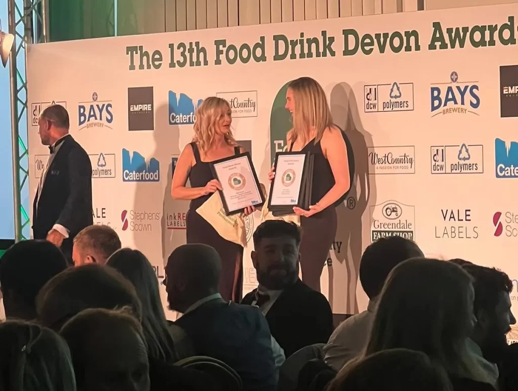 New Festive Flavours in Dawlish 4 Two Woman On Stage Collecting Awards